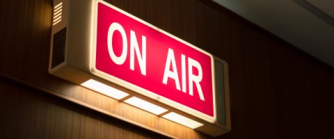 air-sign-icon-glowing-wooden-wall-live-broadcast-radio-production-room_44651-303